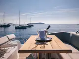 Pail with champagne bottle and two glasses set up on outdoor table on Mowana Yacht