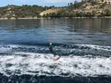 Guest wakeboarding behind Mowana Yacht