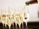 Pouring champagne into eight glasses